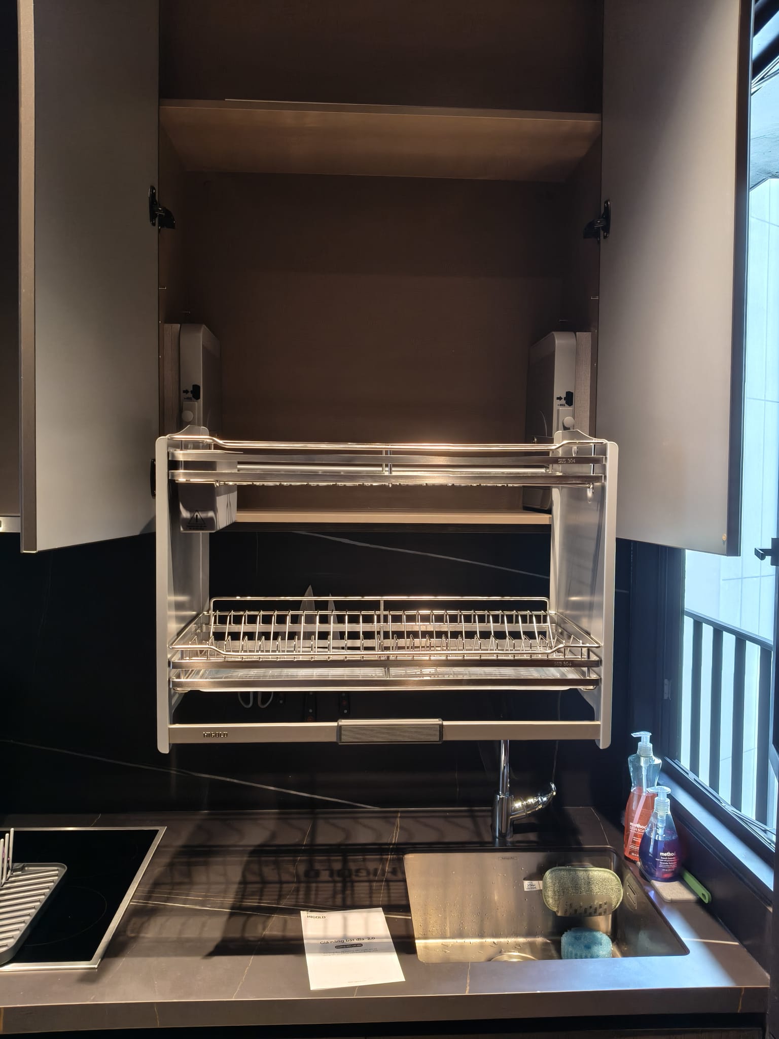 Higold lifting dish rack lowered above sink