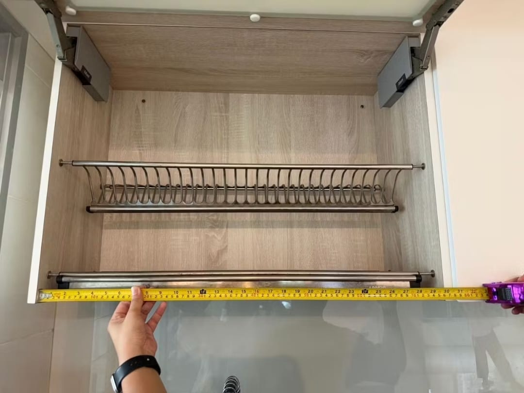 Measuring internal cabinet width with measuring tape